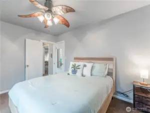Primary bedroom offering natural light, closet, and ceiling fan
