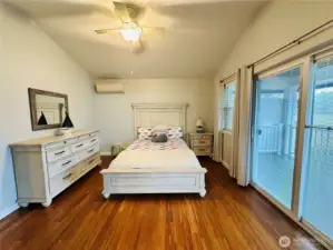 Primary Bedroom with slider going out to large covered deck overlooking the Lake.
