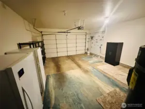 2-car garage with storage shelves and water filtration system