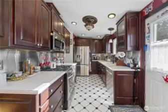 Beautiful cherry cabinets and marble looking corian counters