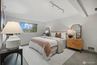 The primary bedroom is bright and invitinng.