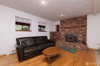 Main floor living room and a wood insert with blower.