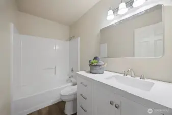 Guest Bath, new lighting, new mirrors, new flooring, new toilet.