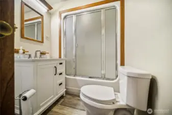 Full bathroom combined with a convenient laundry area.