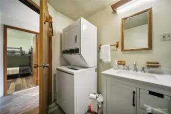 Another angle of the bathroom, showing the integrated laundry space.