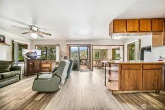 The open-concept living area is filled with natural light and offers stunning views of the lake through numerous windows.