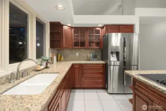 Kitchen features stainless steel appliances  recessed lighting, and a eat-in island with ample storage.
