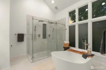 Primary ensuite fully remodeled in 2024 with free standing tub, ceramic shower, two sink vanity and new windows.