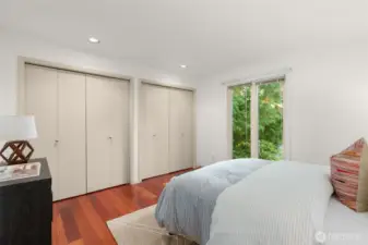 Secondary bedroom features new windows, closet and hardwoods