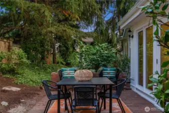 Serene paved backyard with a large side yard.