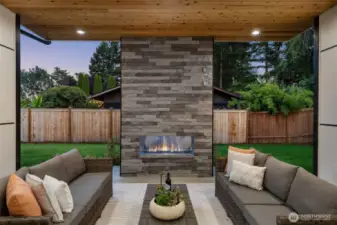 Covered outdoor living with gas fireplace and electric heaters