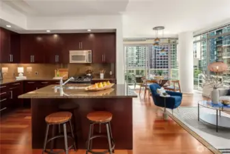 The island features an undermount sink, cabinetry and a breakfast bar.