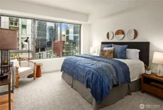 The king sized primary bedroom features new carpet and paint, as well as an ensuite bath and walk-in closet.