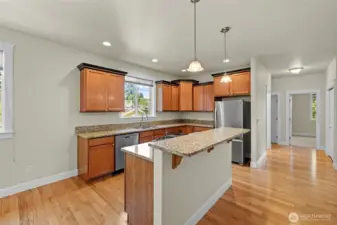 View of the kitchen and looking toward the hall bathroom and two bedrooms