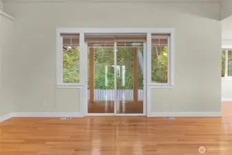 Sliding door that leads to a covered deck and the fenced back yard