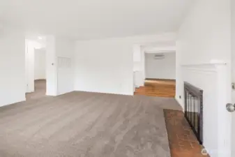 Comfortable front living space with new carpet, wood buring fireplace, and ductless mini split