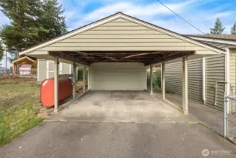 Covered Carport conveniently located near back entrace. Two storage units next to / connected to carport
