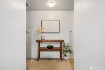 Enter the home into the hallway. To the left is the kitchen up ahead is the living space and bedrooms