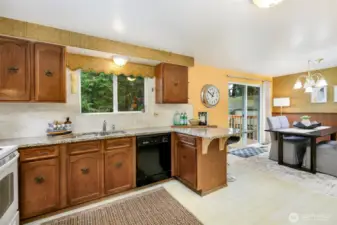 kitchen has solid wood cabinets & granite counters & newer tile back splash