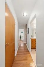 Head down the hall from the kitchen- door on left is large pantry & door on right is full bathroom w/ washer/dryer