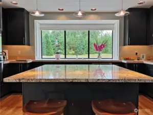 The chef's dream kitchen awaits boasting a stunning granite island with eating bar.