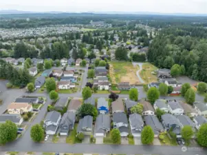 Drone view of the neighborhood.  Home is located in front of the blue home.