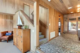 Stone floors in the entry and cedar lined walls are some of the distinctive architectural   features of this home that is in pristine   condition