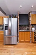 Next to the refrigerator is an INDOOR BBQ GRILL with an updraft exhaust.