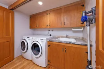 The utility area with a sink is behind the beautiful doors in the dining room area.