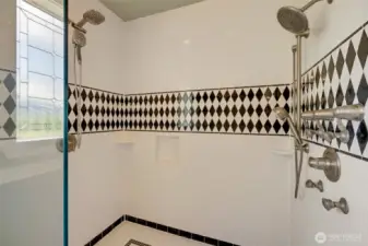 Huge walk-in shower with dual shower heads.