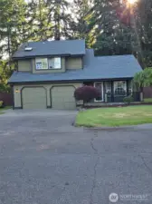 Welcome home to 25608 68th Ave E—this striking front exterior shot showcases the home’s curb appeal with a lush green lawn, long driveway, and charming covered porch. Surrounded by serene trees and natural privacy, this property blends country comfort with Northwest style. Ideal for buyers seeking peace, space, and practicality.