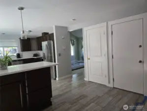 Stylish and functional kitchen with espresso cabinetry, quartz countertops, and stainless appliances flows into the open-concept dining and living areas.