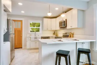 This stunning contemporary kitchen is the heart of the home—beautifully updated to complement the timeless charm of this storybook cottage.