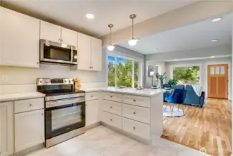 A freshly laid tile floor in the kitchen and beautifully refinished hardwood floor in the living room bring warmth and elegance to every step.