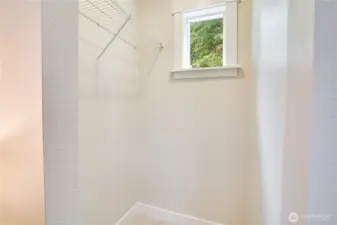 Even the closet gets a dose of sunshine—thanks to a thoughtfully placed window that brings in natural light.
