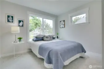 The second bedroom boasts fresh carpet, new elevated millwork, and sunny windows that offer and soft natural light making this a perfect retreat.