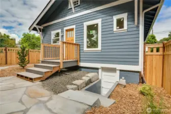 Just a few finishing touches left on the back stairs—let’s take a peek at the unfinished basement accessed by the door to the left.