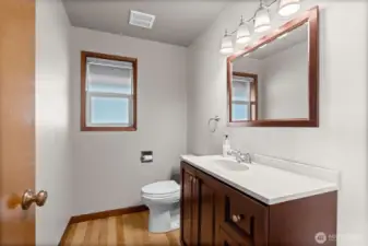 Hard-surfaced powder bath thoughtfully positioned just off the front door.