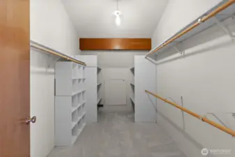 A spacious primary closet with plenty of room for all your wardrobe needs.