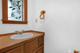 Main floor powder room with stained glass window.