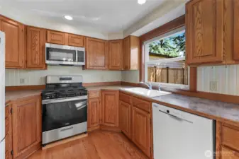 Kitchen with gas stove, microwave and dishwasher.