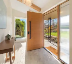 Front entry framed with large windows.