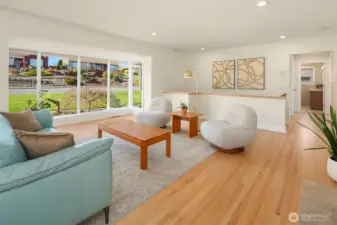 Refinished hardwoods and large picturesque windows complete the room.