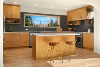 Designer kitchen with custom rift oak cabinetry & island seating.