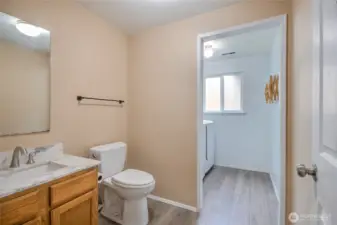 First floor guest bathroom displaying new paint new flooring and countertop