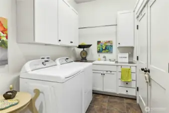 The laundry room has lots of storage and is conveniently located .