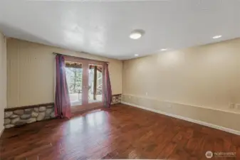 Lower level bedroom with access to the backyard offers flexibility for guests, multigenerational living.