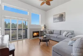 The spacious living room offers a cozy gas fireplace and walk out balcony