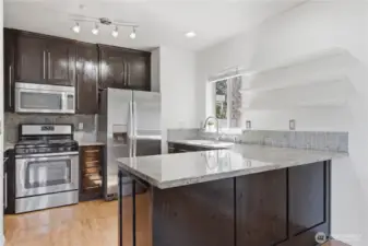 This fairly recently renovated eat-in kitchen is elegant and well appointed with beautiful countertops, cabinetry (freshly oiled to help preserve the wood), and stainless steel appliances.