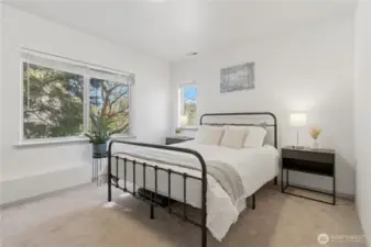 The primary bedroom is bright, spacious and could easily accommodate a king sized bed. (Queen sized bed shown)